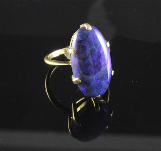 A gold and black opal ring, size O.